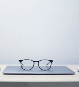 Glasses on a closed laptop